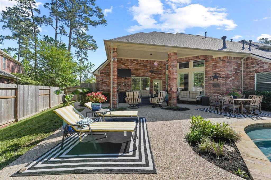 Impressive backyard space perfect for entertaining with a sparkling pool, hot tub, covered patio, backyard green space, updated landscaping, Wi-Fi controlled sprinkler system, new roof, and recently replaced fence.