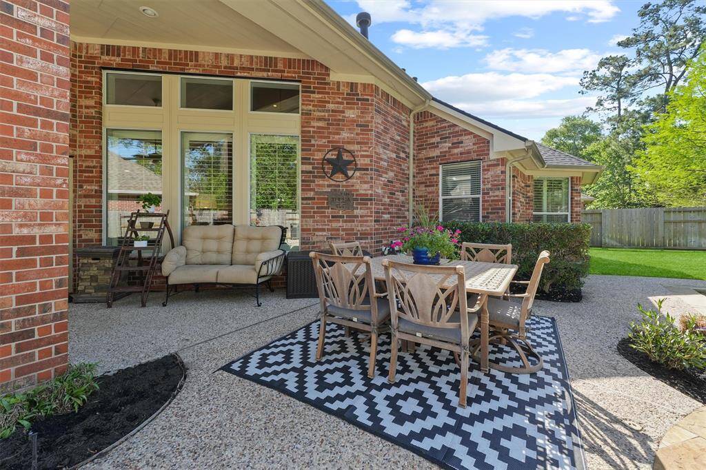 Impressive brick covered patio with ceiling fan to beat the Texas heat.