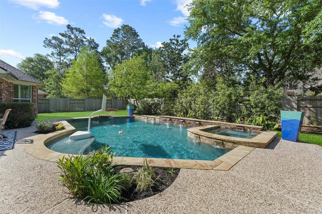 The sparking in-ground gunite pool has a custom stone waterfall wall and hot tub. The pool heater was replaced in 2024. The pool filter was replaced in 2025. Most of the pool pumps have been replaced. There is a new pool cleaner. There is updated landscaping work completed in the backyard.