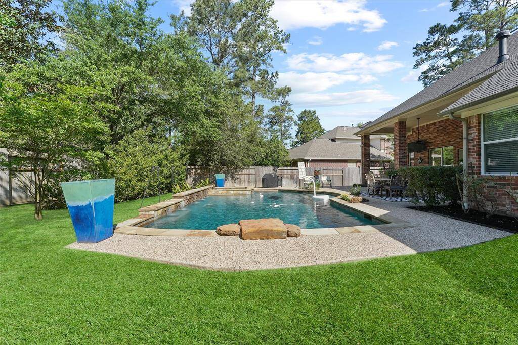 The sparking in-ground gunite pool has a custom stone waterfall wall and hot tub. The pool heater was replaced in 2024. The pool filter was replaced in 2025. Most of the pool pumps have been replaced. There is a new pool cleaner. There is updated landscaping work completed in the backyard.