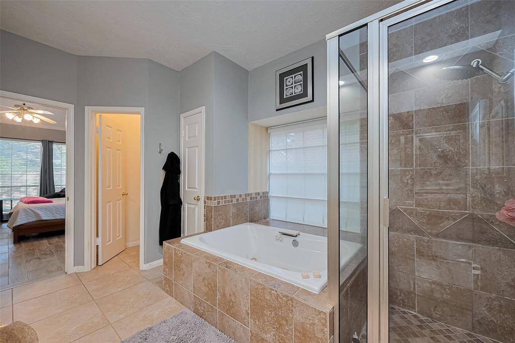 Primary bath with jetted soaking tub and separate shower.