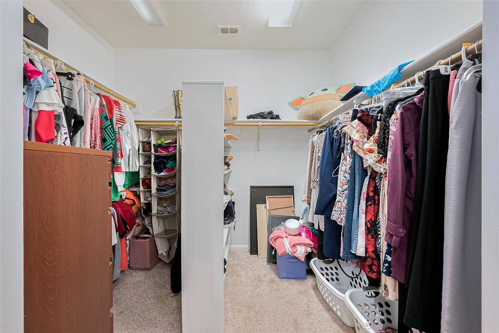 Walk in closet in primary bedroom
