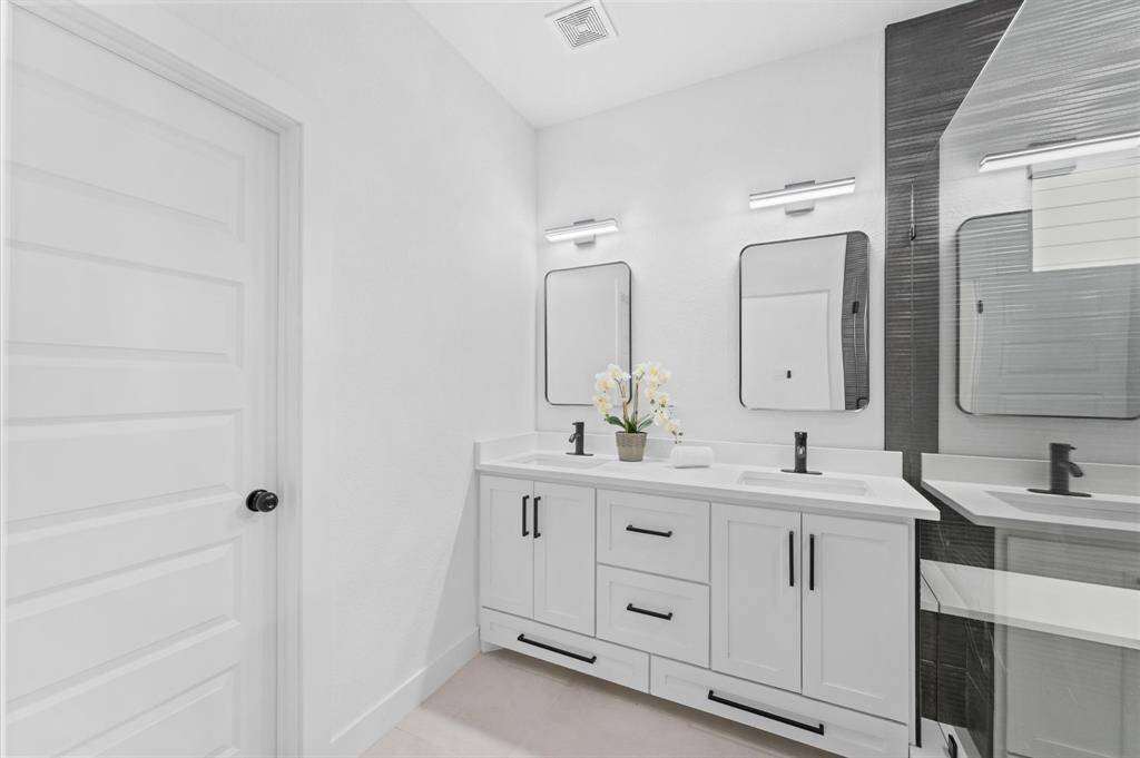 The primary bath Includes a dual sink vanity space.