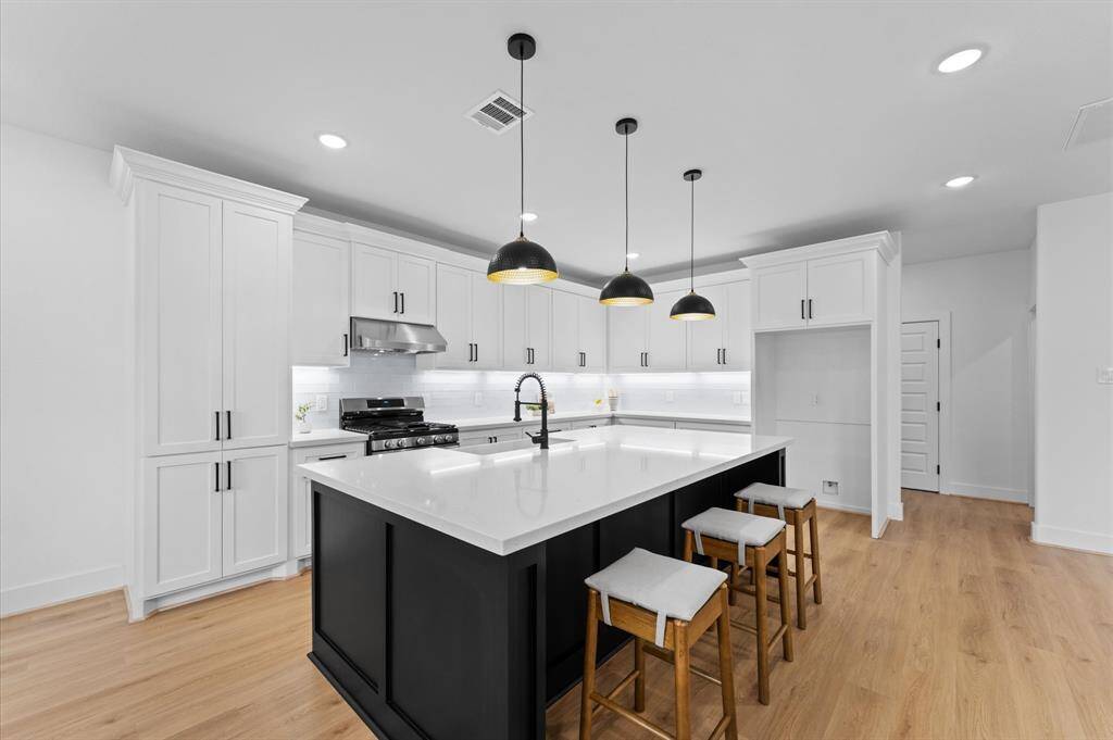 The crisp black and white contrast in the kitchen creates stylish elegance.