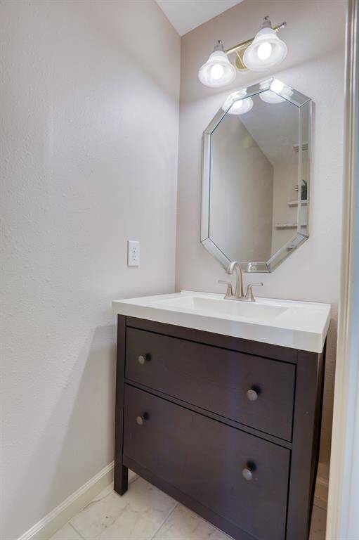 This stylish half bath offers both convenience and elegance, with tasteful finishes and a well-appointed design. Perfectly located for guests, it combines functionality with a touch of luxury.