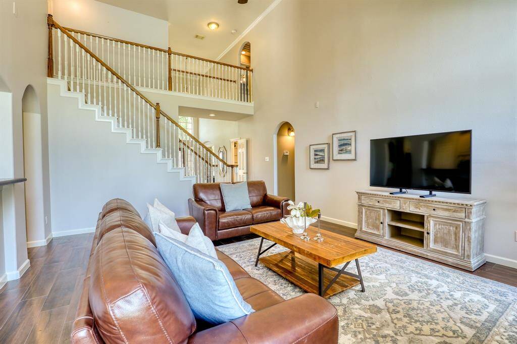 Living room features high ceilings and great natural light, creating an open and inviting atmosphere.