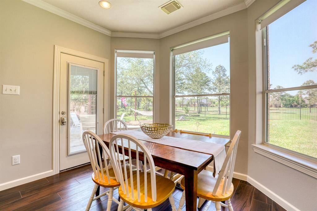The charming bay window breakfast nook offers a cozy spot to enjoy your morning coffee while taking in serene views of the golf course.