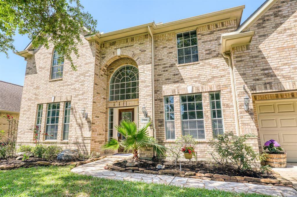 Charming curb appeal with a well-maintained exterior, lush landscaping, and a welcoming front entry.