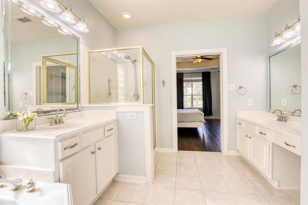 Separate vanities provide generous space and enhance convenience, making the primary bath both functional and stylis