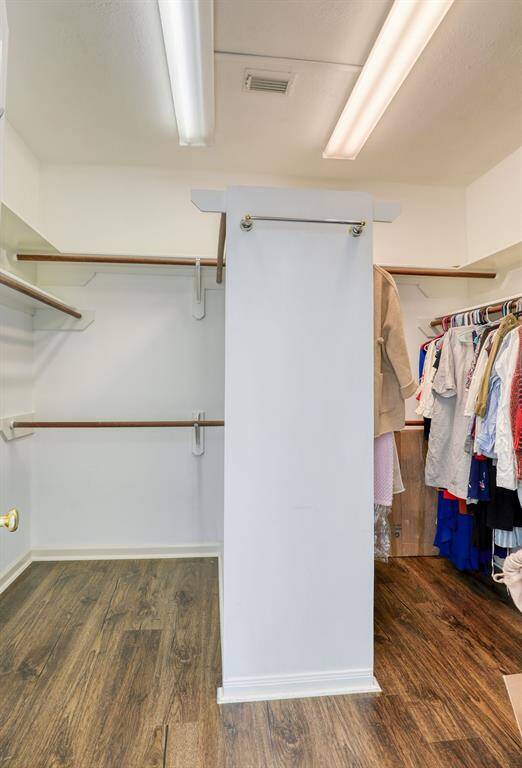 The primary bedroom features a spacious walk-in closet, offering ample room for organization and easy access to your wardrobe