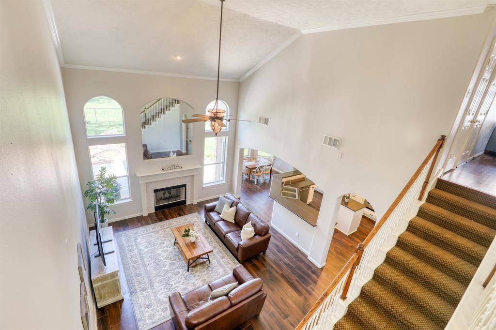 A view of the living room from above highlights the open layout and impressive ceiling height.