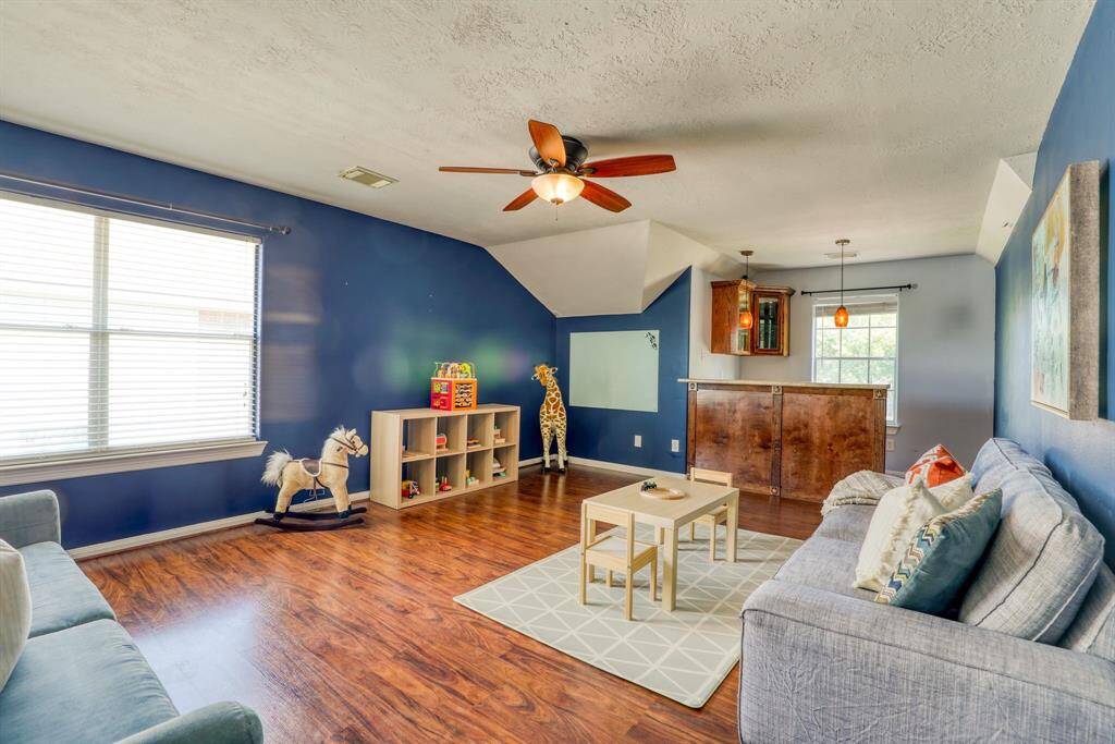 The game room is an entertainer's dream, featuring a stylish bar and built-in wine cooler, perfect for hosting guests and enjoying your favorite games