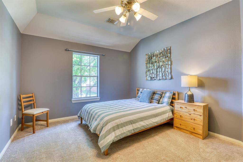 A spacious and inviting bedroom with ample natural light, offering a peaceful retreat for rest and relaxation