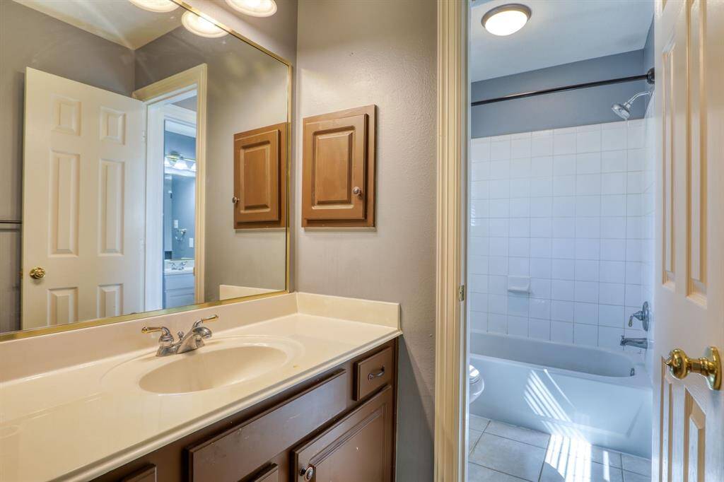 The Jack and Jill bath is designed for convenience and privacy, featuring separate vanities and a shared shower area, making it ideal for shared living spaces