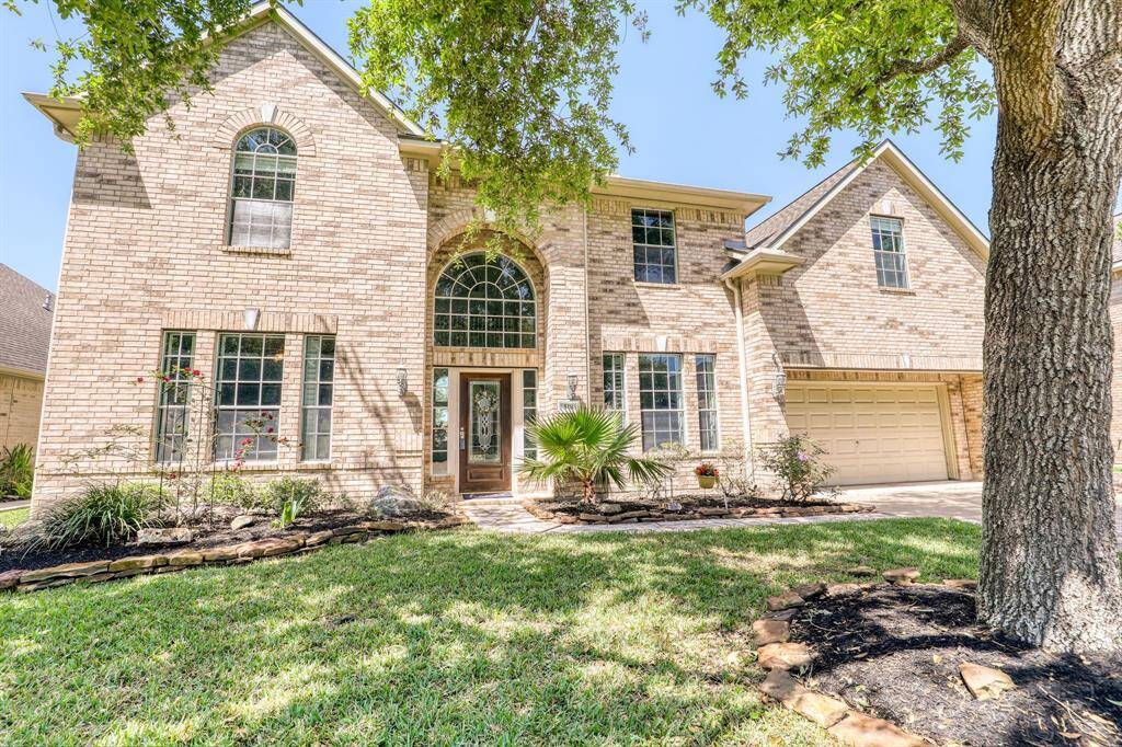 Charming exterior surrounded by mature trees, offering privacy and a peaceful atmosphere