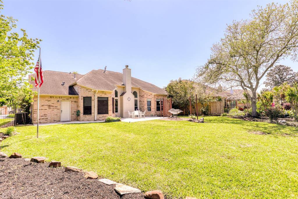 Another view of the yard, showcasing its spacious layout and potential for outdoor activities or landscaping.