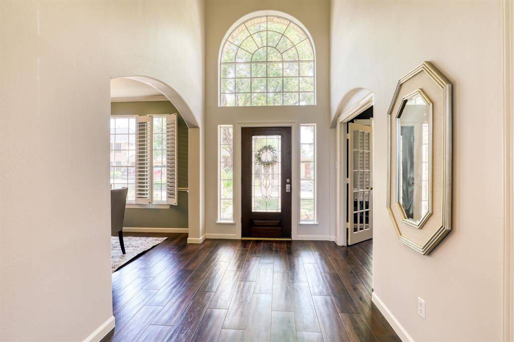Step into luxury with a grand entry that sets the tone for the entire home. Soaring ceilings, elegant details, and expansive space create a stunning first impression, welcoming you into a world of sophistication and style.
