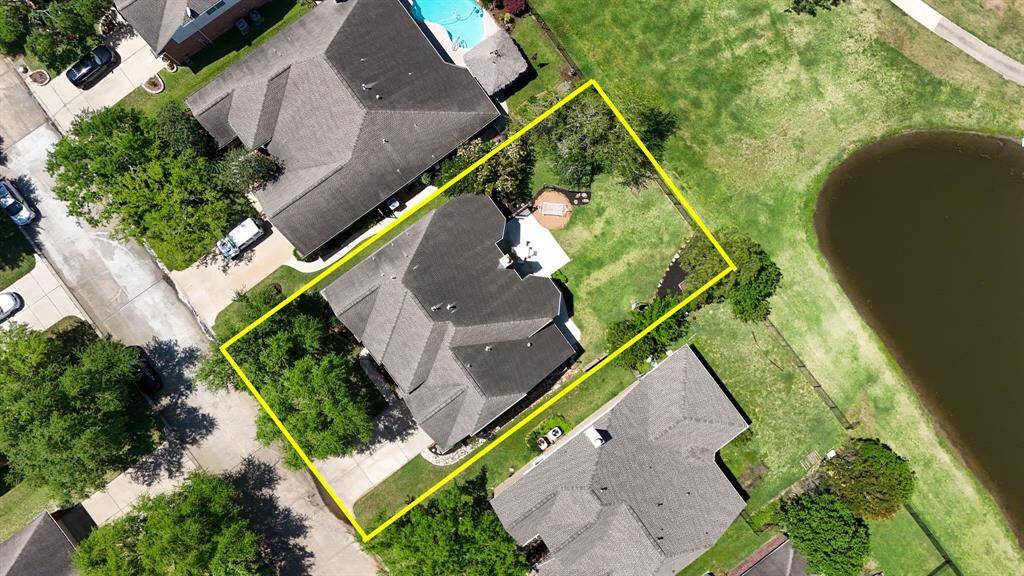 Aerial view of the home and pond, offering a stunning perspective of the property’s serene surroundings.