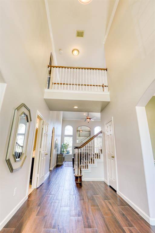 As you enter, you're greeted by a grand high-ceiling entry that exudes spaciousness and elegance. The soaring ceilings create an immediate sense of openness, setting the stage for the home's luxurious and airy feel.