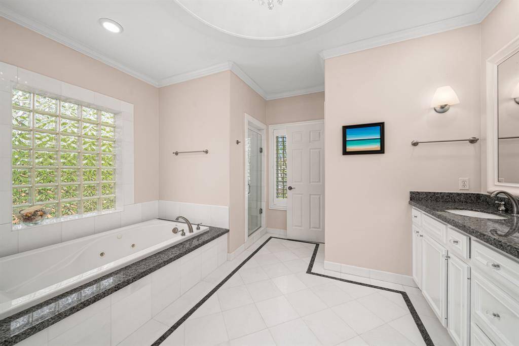 Primary bathroom with 2 walk-in closets, jetted tub and stand-up shower.