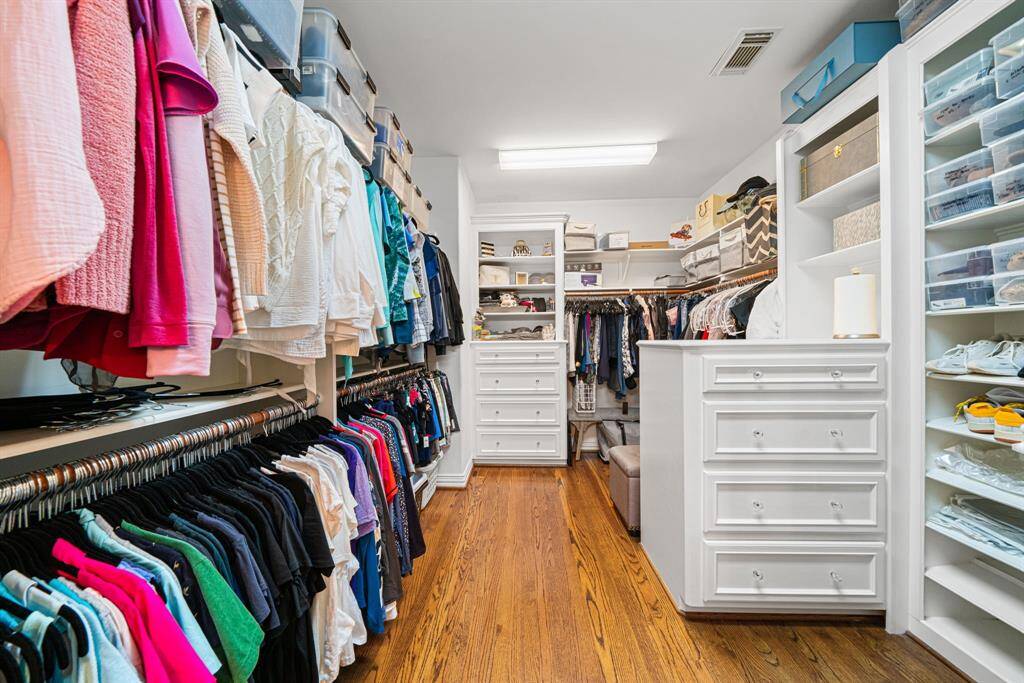 1 of 2 walk-in closets. Larger Primary bedroom closet with vanity area and cedar closet at entrance in next photo.