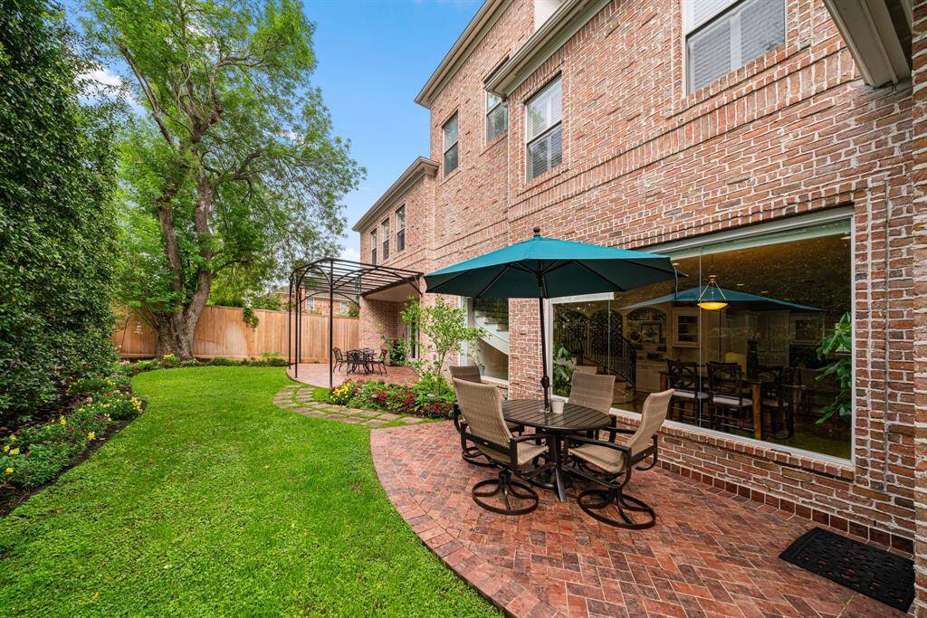 Double patios. Lovely lush landscaping in the backyard space.