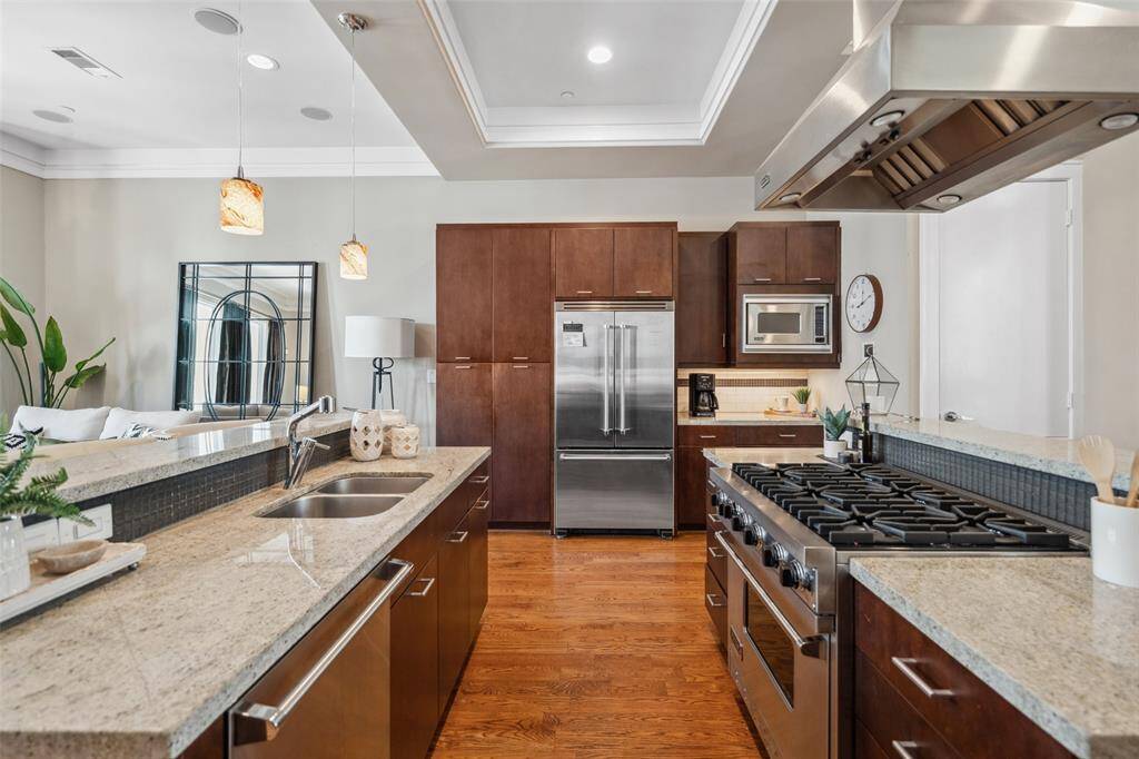 On the opposite side of the kitchen, you’ll find the built-in Viking refrigerator and microwave, abundant pantry storage, and a dedicated coffee bar—thoughtfully designed for both daily convenience and effortless hosting. A warming drawer is also discreetly tucked away, completing the premium appliance package.