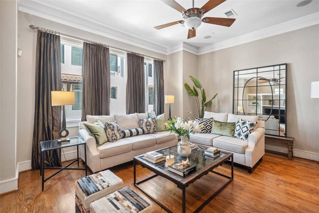 A wall of windows floods the living space with natural light, enhancing the open feel and creating a bright, inviting atmosphere throughout the second floor.
