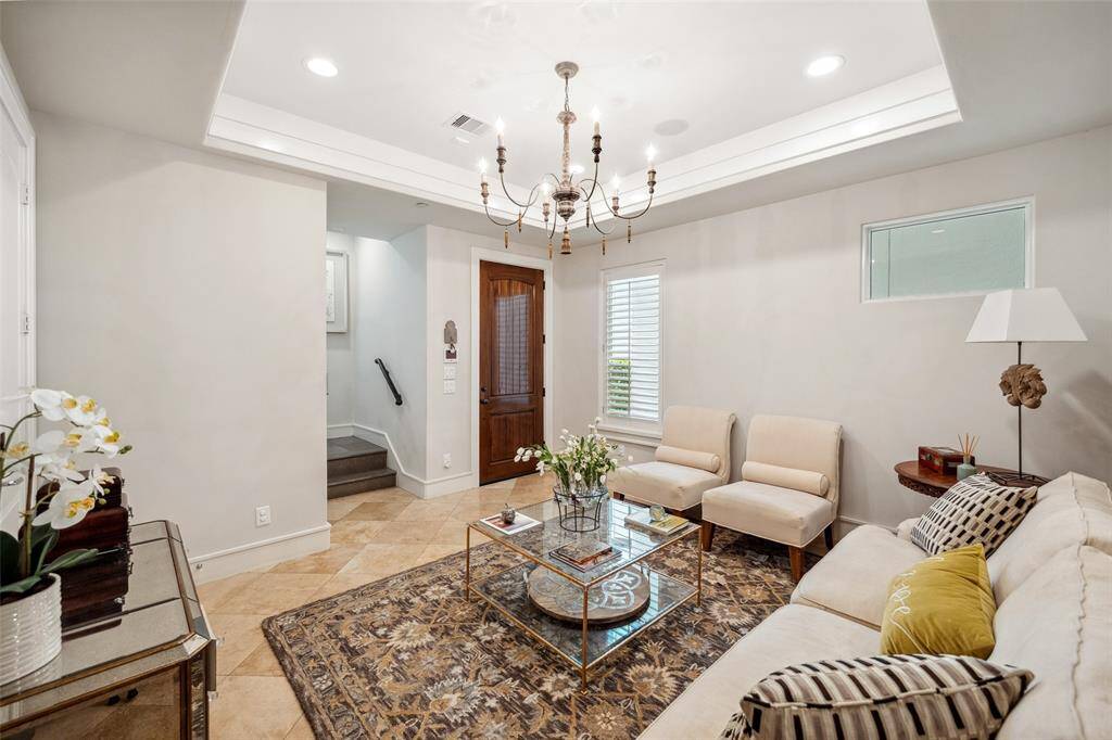 From this angle, you can appreciate the reception room’s connection to the front entry and the elegant stairway that leads to the upper floors—setting a gracious tone right from the start.