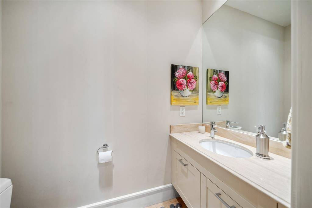 A stylish powder bath serves the first floor, complemented by a generous coat closet with plenty of storage—ideal for welcoming guests with both function and flair.