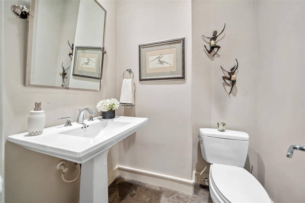 Tucked on the stair landing just before the second floor, a conveniently located powder bath adds both function and privacy—perfect for guests or quick stops between levels.