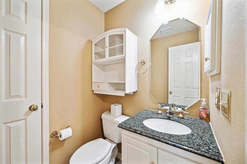 Conveniently located near the formal living room and den, this stylish powder room offers both elegance and accessibility.
