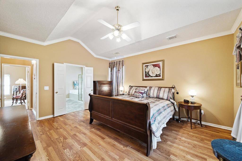 Elevate your living experience in this primary suite, featuring soaring ceilings, a generous window, and a private en-suite bathroom with a walk-in closet.