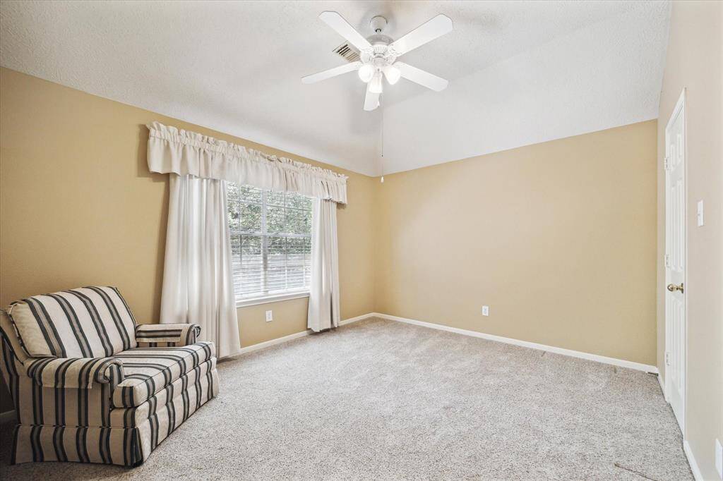 Cozy second-floor bedroom with ample natural light.