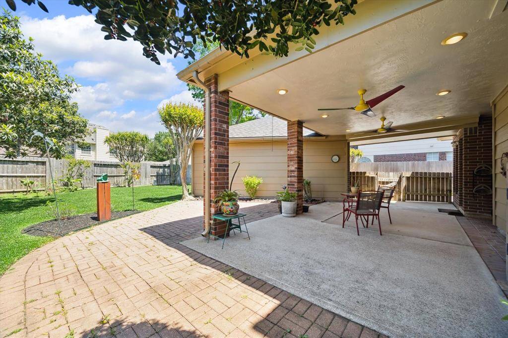 Experience the perfect outdoor retreat with this spacious, covered patio, offering ample shade and stunning backyard views.