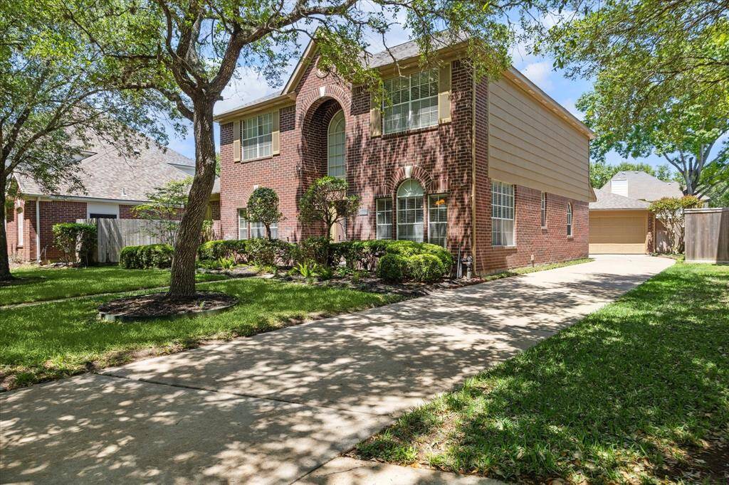 Embrace the inviting charm of this yard, complete with the soothing shade from beautiful oak trees.