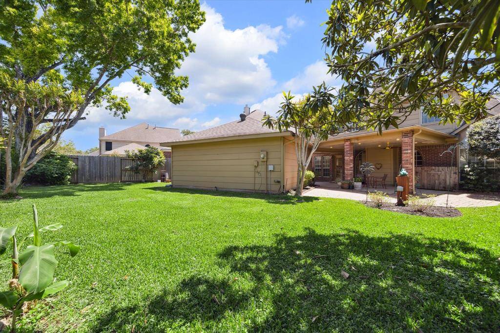 Discover a spacious yard complemented by a generous covered patio, perfect for relaxation and entertaining.