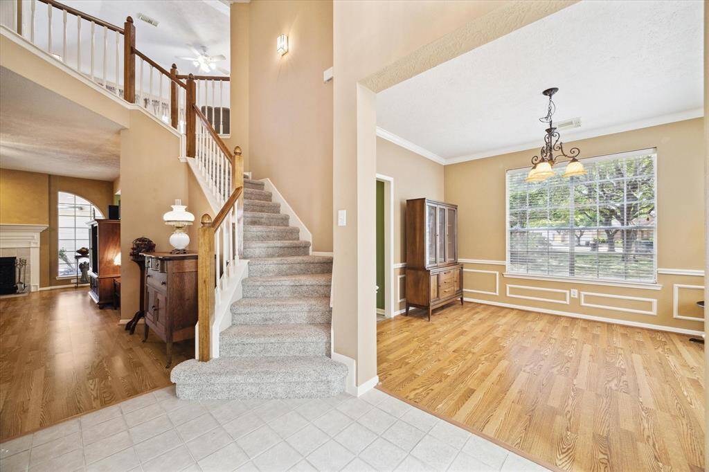 Step into a welcoming foyer featuring an elegant staircase leading to the second floor.