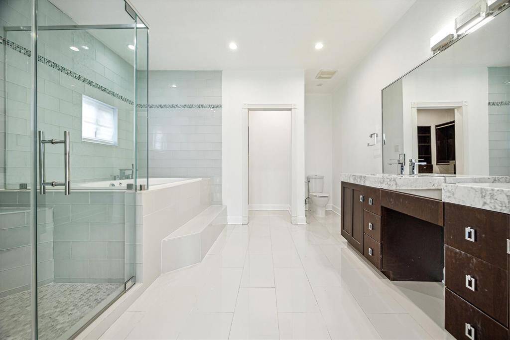 LUXURIOUS MASTER BATHROOM WITH ENORMOUS TUB & VAST WALK-IN SHOWER.