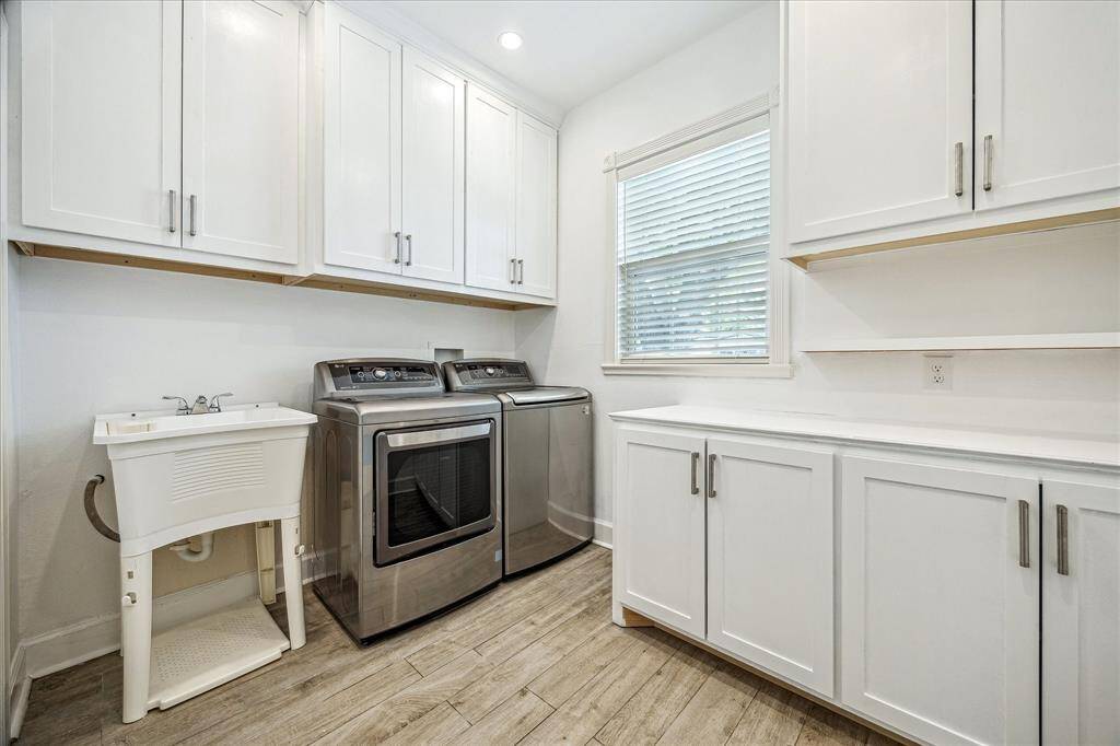 FUNCTIONAL & SPACIOUS UTILITY ROOM HOSTS A PLETHORA OF CABINETS, LARGE PRACTICAL SINK & FULL SIZE WASHER & DRYER.