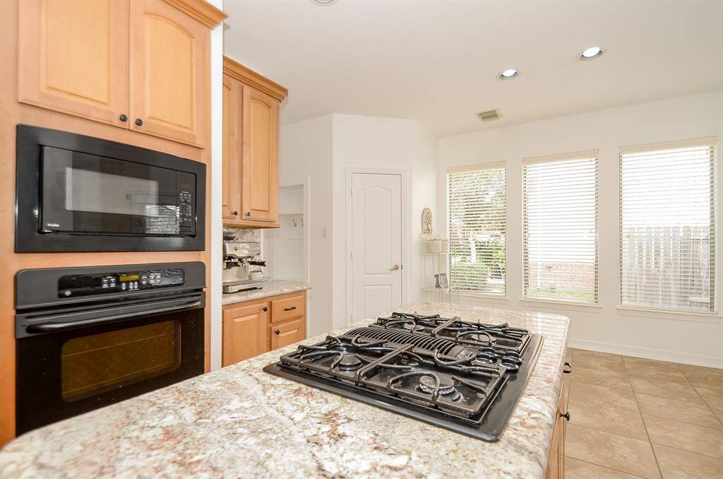 A closer look at the appliances.  Door ahead is the walk in pantry.  The utility room (on the left of the pantry) is oversized with room for an additional refrigerator and a work area for folding laundry.  There are 2 windows in there making spot-treating easier on laundry days.