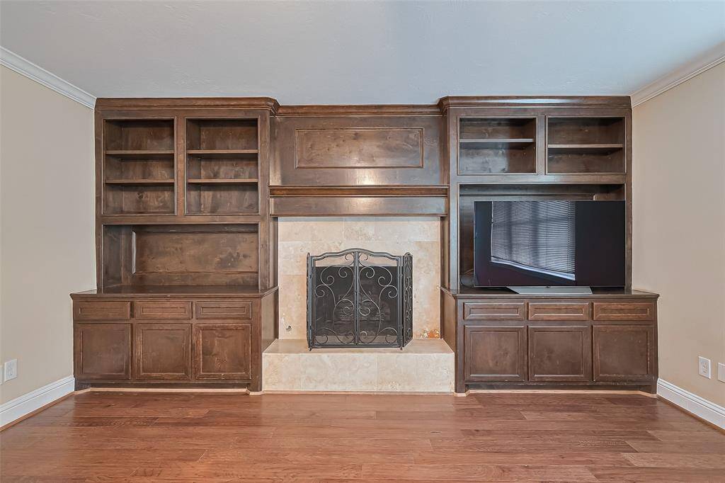 Cozy up by the elegant fireplace, framed by exquisite custom cabinetry.