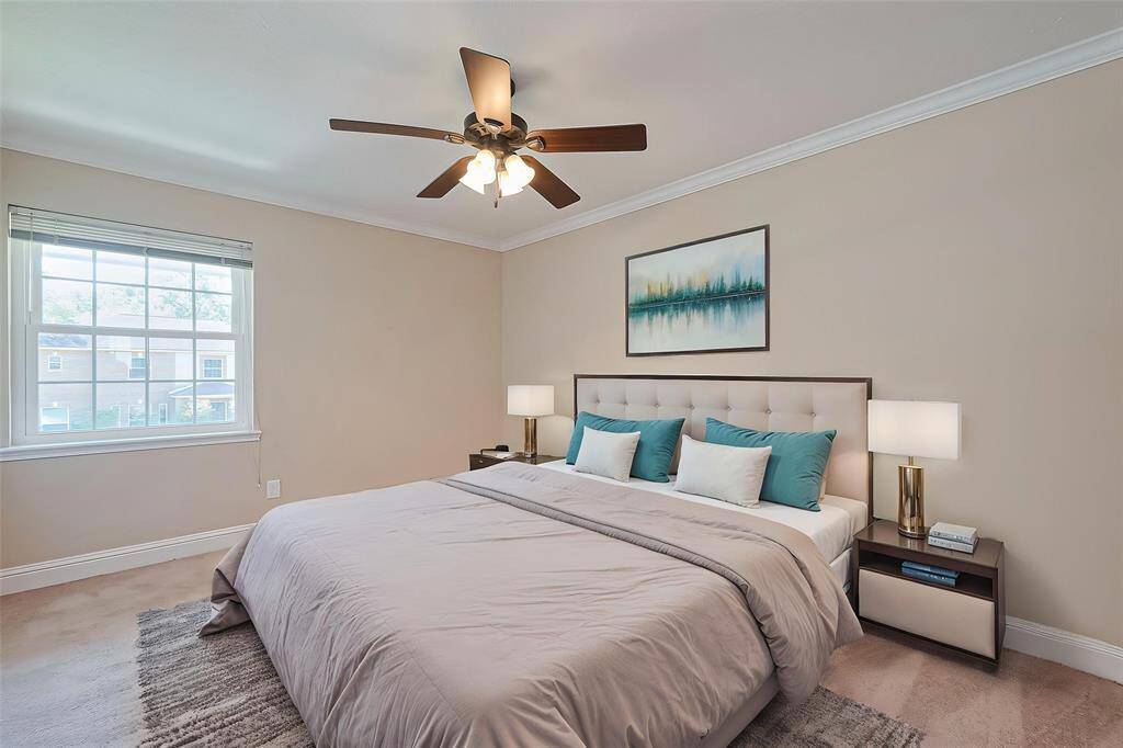 Virtually staged. Secondary bedroom #2 featuring soft lighting, a spacious layout, and a large window for natural light with walk-in closet.