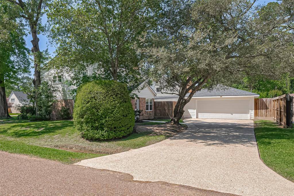 Expansive side driveway leading to a spacious two-car garage.