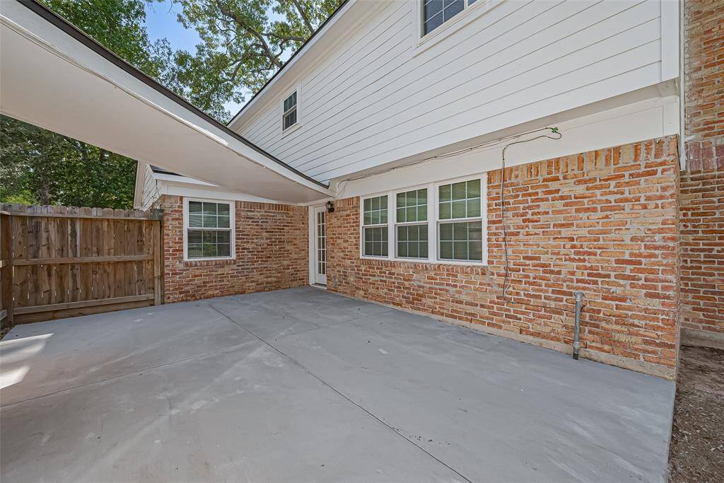 Spacious concrete patio perfect for outdoor gatherings and relaxation.