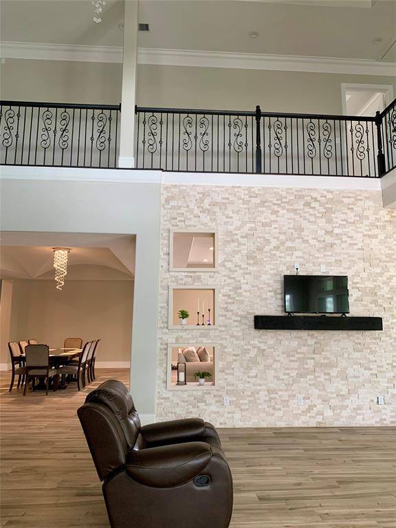 View of the den area separated from the living area by a partial wall creating a warm atmosphere.