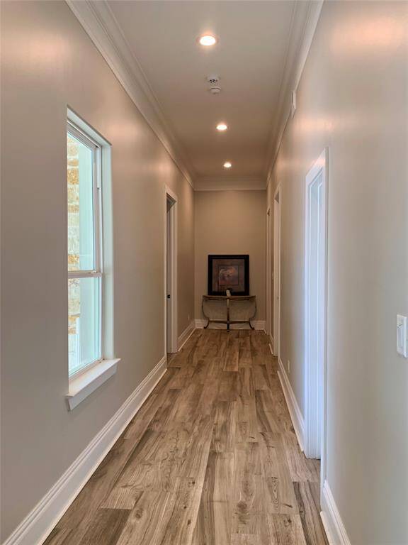 Just behind the stairs and down the hall are two primary sized bedrooms located on eitheir side of the long hall.