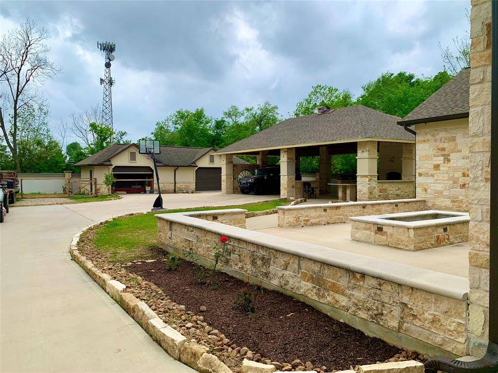 View of the back yard and two double garages. A fenced area next to the garage is currently being used as a dog run. It has endless possibilities from gardening area to hobby area etc.