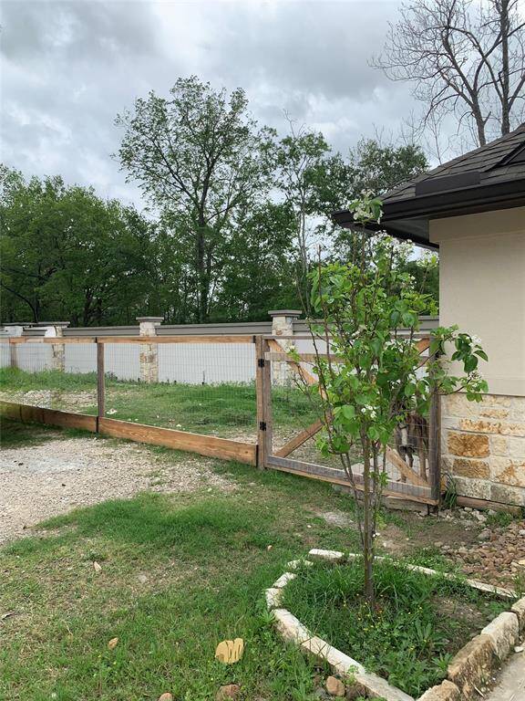 Fenced area located just beside the garages with endless possibilities.