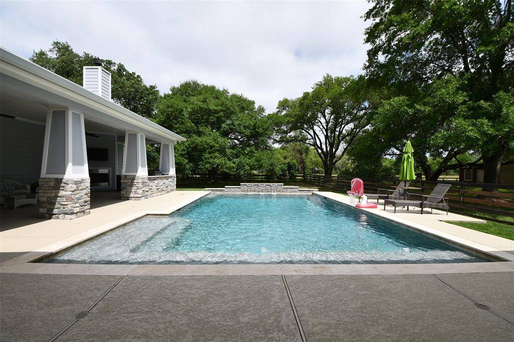 Soothing sound of cascading waterfalls at the deep end of this sparkling pool. With a 3-foot shallow entry that gradually deepens to 8 feet, it's perfect for both peaceful lounging and lively summer fun.